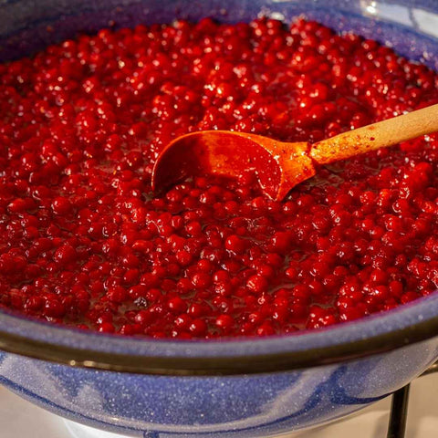 Cooked wild Alaska lingonberries in a blue bowl