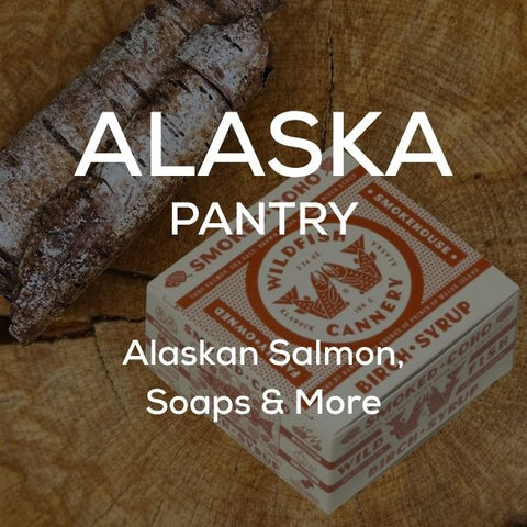 White text stating "Alaska Pantry: Alaskan Salmon, Soaps & More" on top of an image of smoked coho salmon.