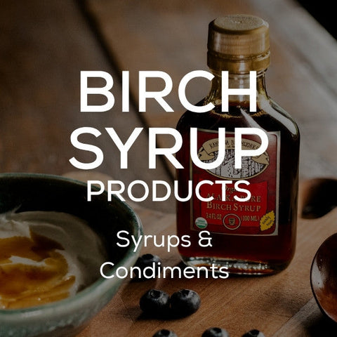 White text stating "Birch Syrup Products: Syrups and Condiments" in front of an image of Alaska birch syrup standing on a log