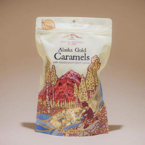 A bag of 10oz Alaska Gold Caramels by Kahiltna Birchworks with an image of an Alaska forest on the bag.