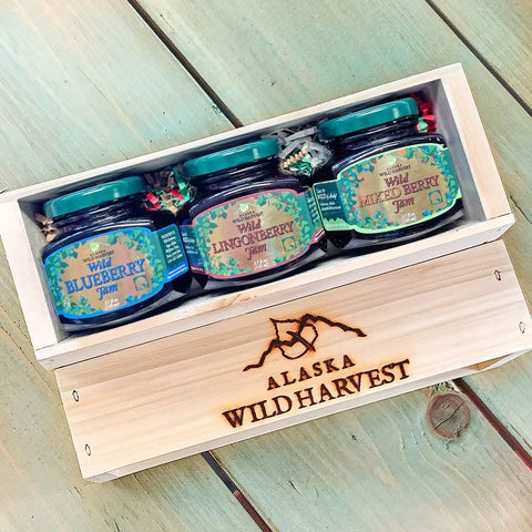 Wooden gift crate of Alaska Wild Harvest jam jars on a wooden surface