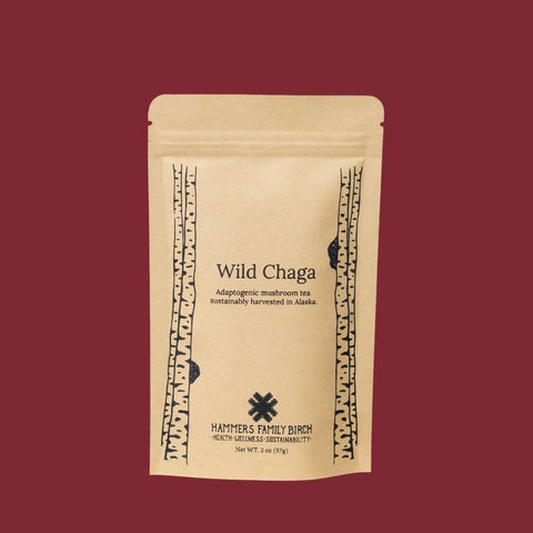 2oz Kraft bag of Hammers Family Birch Wild Chaga Tea on a maroon backgrond. 