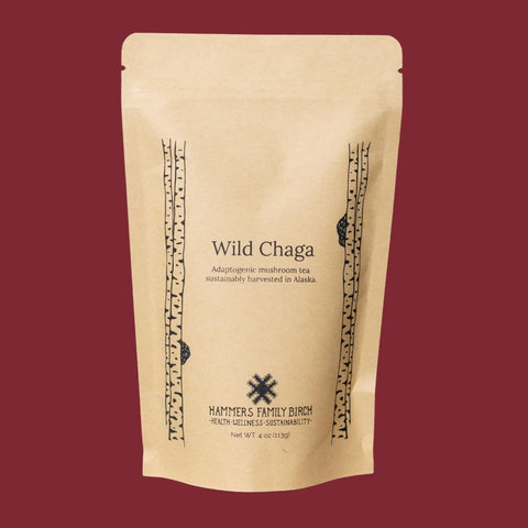 4oz Kraft bag of Hammers Family Birch Wild Chaga Tea on a maroon backgrond. 